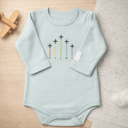 Sage green long sleeve baby bodysuit with ARROWS graphic, lifestyle view – Kumy Kids