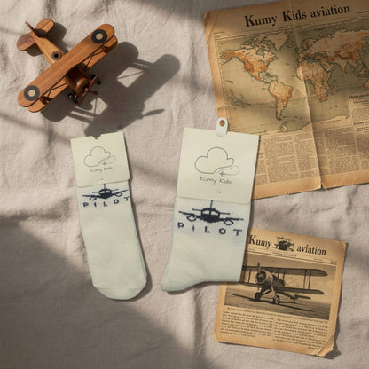 Beige PILOT baby socks styled with teddy bear, lifestyle view – Kumy Kids